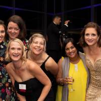 Guests smiling and posing in the Laker Lounge.